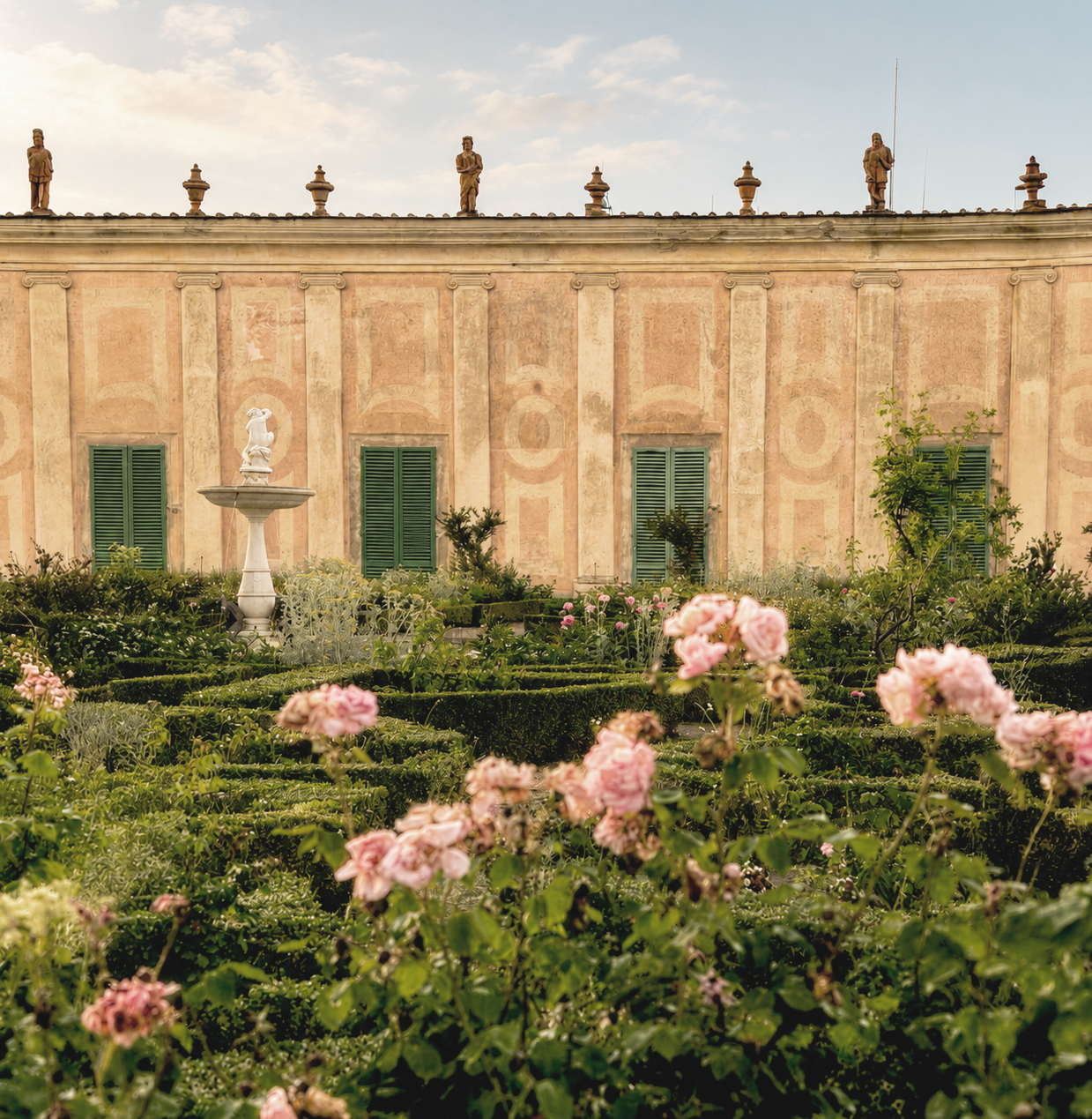 Rolling green hills and a cypress-lined villa in the Tuscan countryside